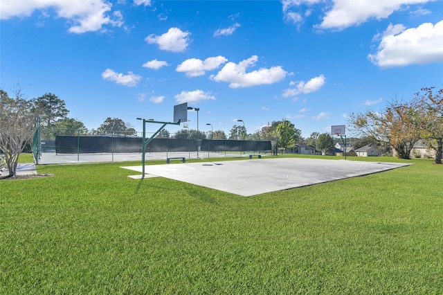 view of sport court with a yard