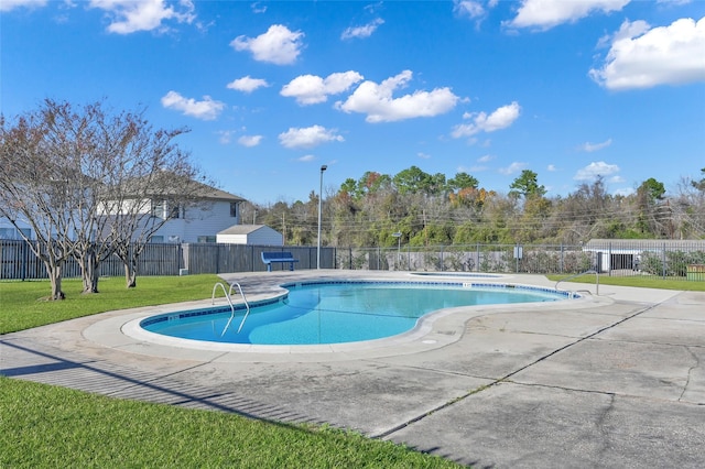 view of pool with a yard and a patio