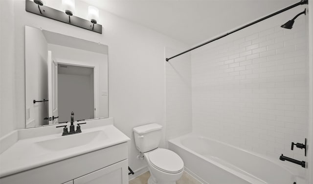 full bathroom with tiled shower / bath, vanity, and toilet