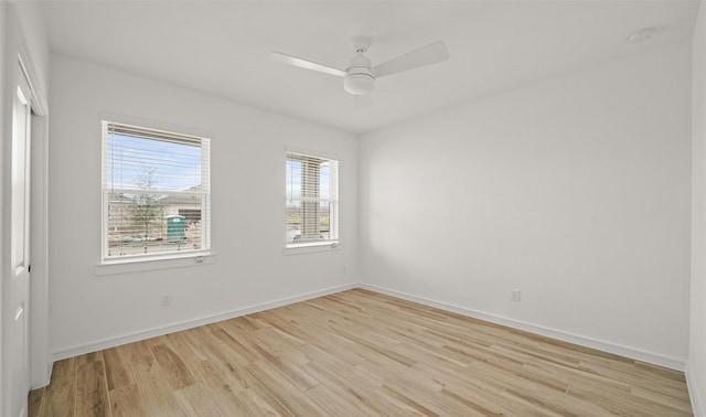 empty room with light wood-style floors, ceiling fan, and baseboards