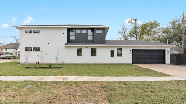 view of front of property featuring a garage and a front yard