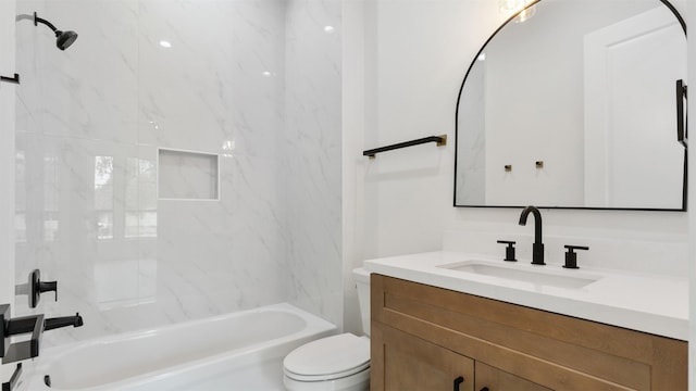 full bathroom with vanity, toilet, and tiled shower / bath