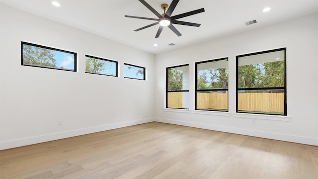 unfurnished room with ceiling fan and light wood-type flooring