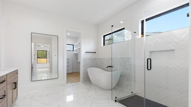 bathroom with shower with separate bathtub, vanity, and a wealth of natural light