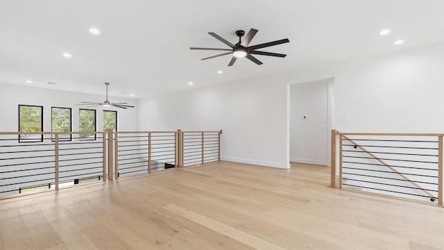 spare room featuring light wood-type flooring and ceiling fan