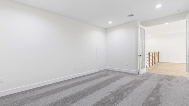 unfurnished room with light carpet