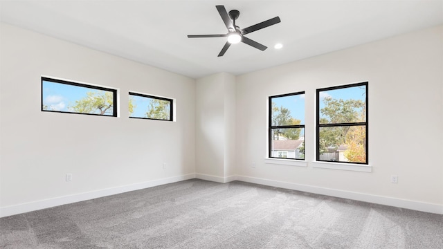 spare room featuring carpet and ceiling fan