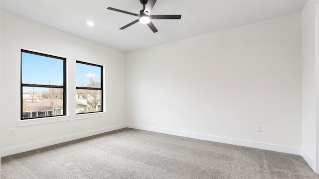 spare room featuring carpet and ceiling fan