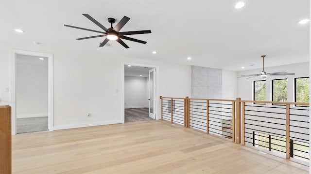 empty room featuring ceiling fan and light wood-type flooring