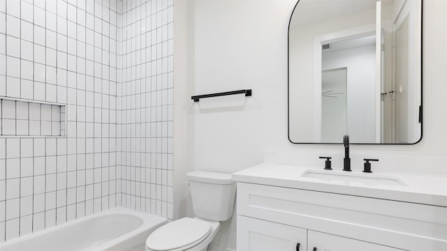 full bathroom featuring vanity, toilet, and tiled shower / bath combo