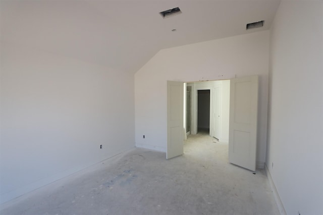 spare room featuring lofted ceiling