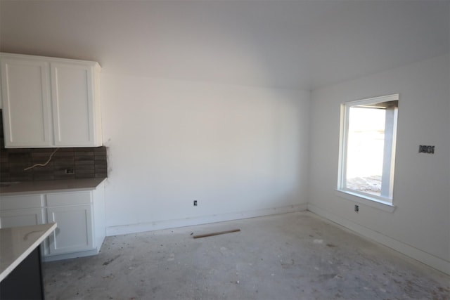 unfurnished dining area with baseboards