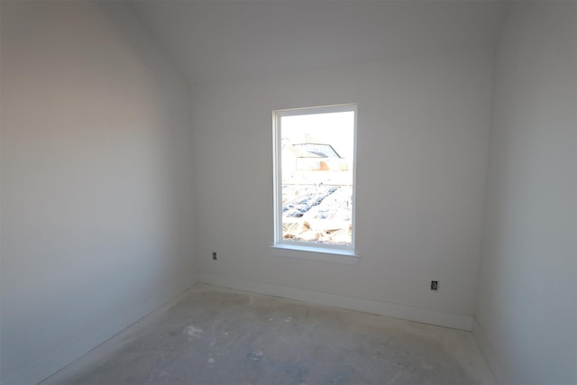 unfurnished room with concrete flooring and baseboards