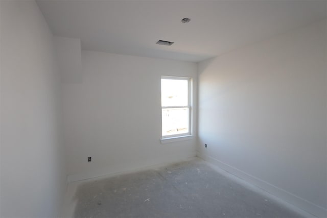 unfurnished room with visible vents and baseboards