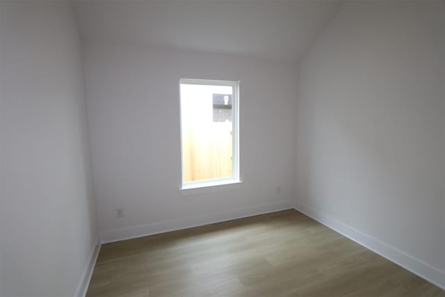 empty room featuring baseboards and wood finished floors