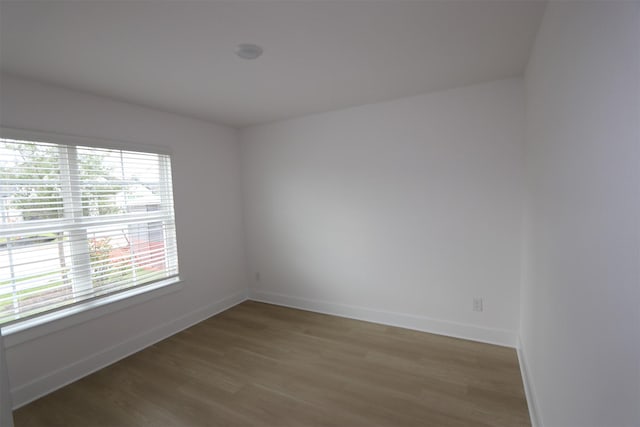 empty room with baseboards and light wood finished floors