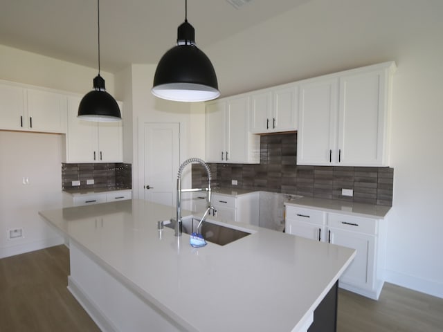 8622 Sun Coral Dr, Cypress, TX 77433 - kitchen with backsplash, wood finished floors, baseboards, and a sink