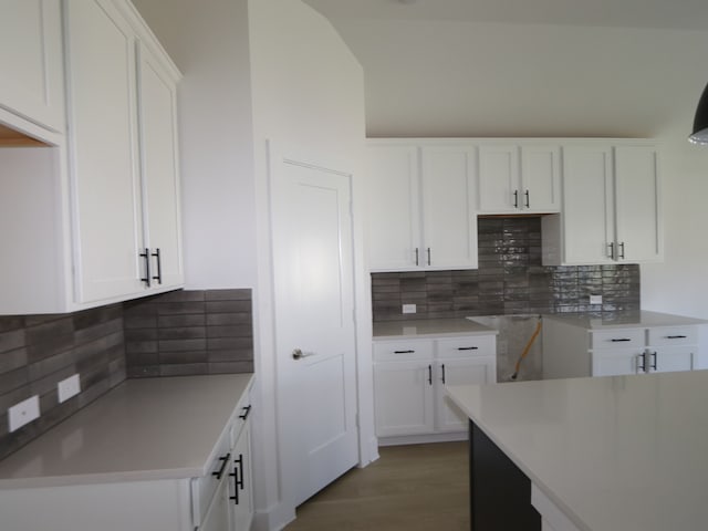 8622 Sun Coral Dr, Cypress, TX 77433 - kitchen featuring white cabinetry, decorative backsplash, light countertops, and light wood-style floors