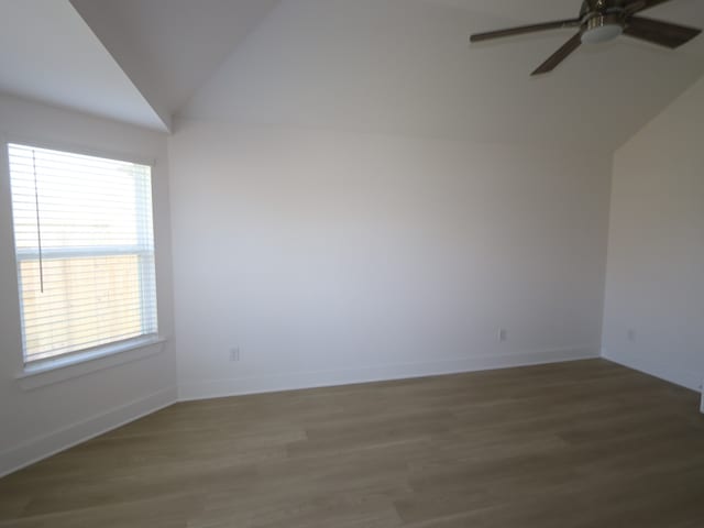 8622 Sun Coral Dr, Cypress, TX 77433 - unfurnished room featuring vaulted ceiling, baseboards, a ceiling fan, and wood finished floors