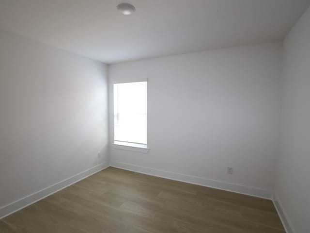 8622 Sun Coral Dr, Cypress, TX 77433 - unfurnished room with baseboards and wood finished floors