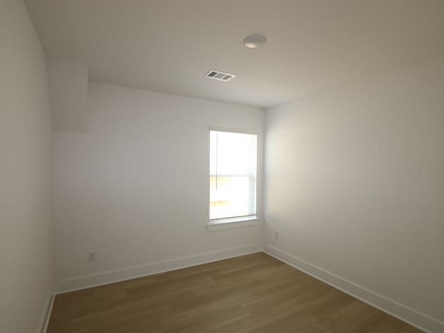 8622 Sun Coral Dr, Cypress, TX 77433 - unfurnished room with baseboards, visible vents, and wood finished floors