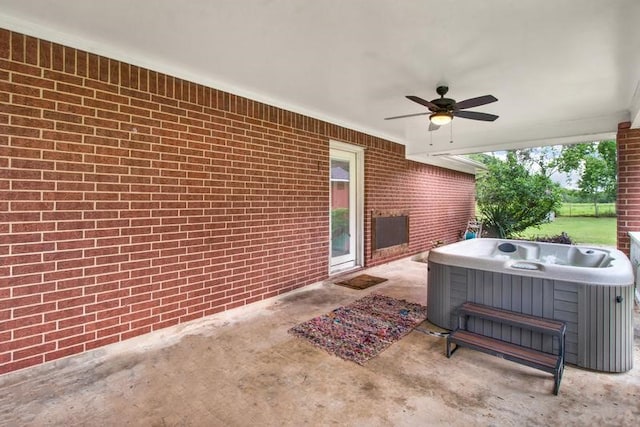 view of patio / terrace with a hot tub and ceiling fan