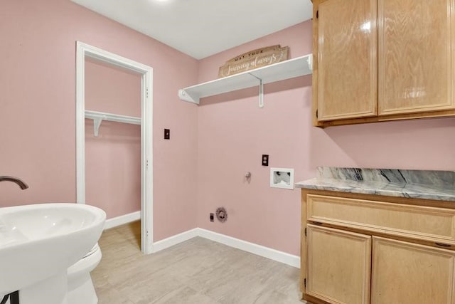 laundry area with hookup for a washing machine, gas dryer hookup, and sink