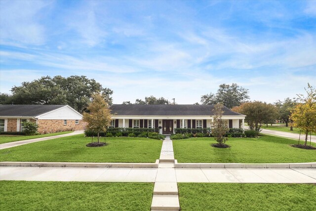 ranch-style home with a front lawn