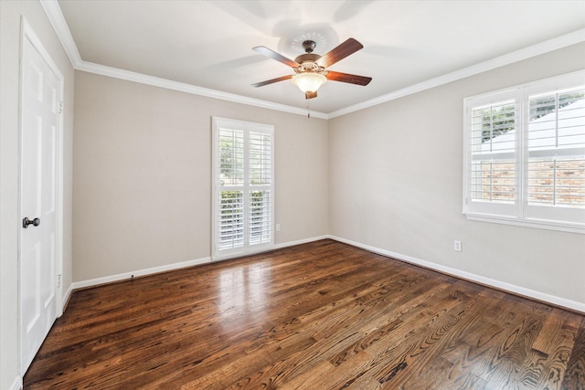 spare room with plenty of natural light, dark hardwood / wood-style flooring, and ornamental molding