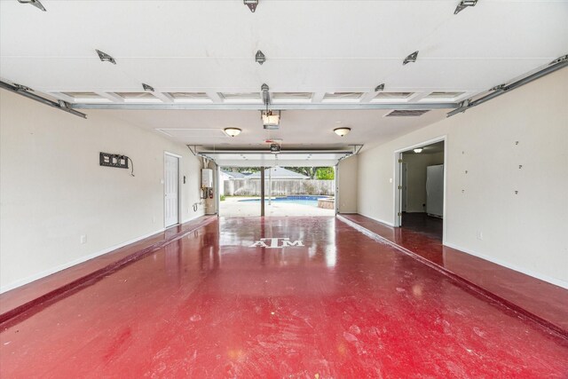 garage with an indoor pool, a garage door opener, and white refrigerator