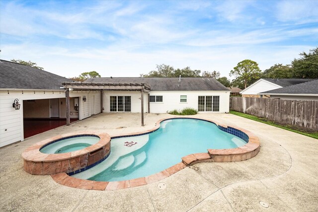 view of swimming pool featuring a patio area and an in ground hot tub