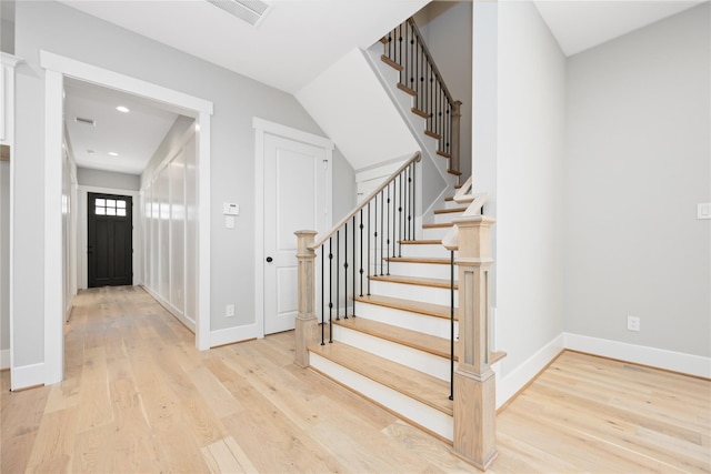 stairway featuring wood-type flooring