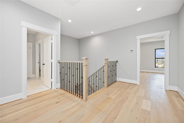 corridor with light hardwood / wood-style floors