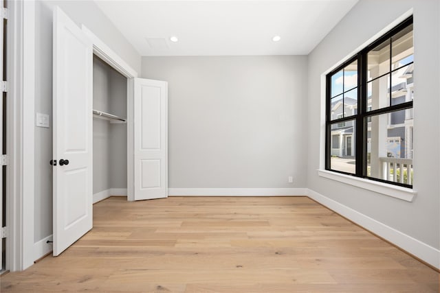 unfurnished bedroom with light wood-type flooring