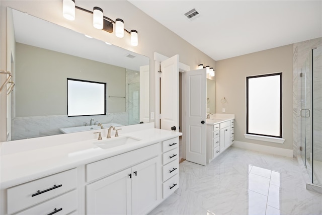 bathroom featuring vanity and a shower with shower door