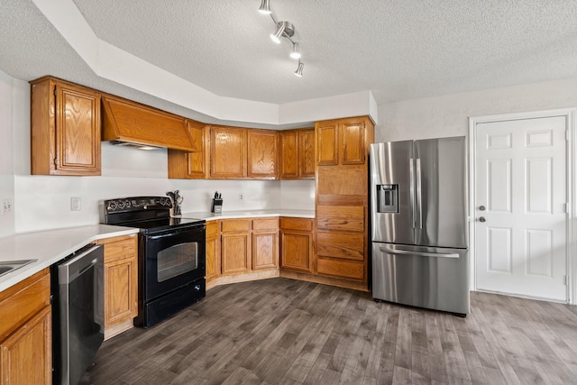 kitchen with black appliances, dark hardwood / wood-style floors, a textured ceiling, and track lighting