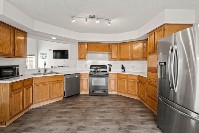 kitchen featuring dark hardwood / wood-style flooring, sink, black appliances, and a textured ceiling