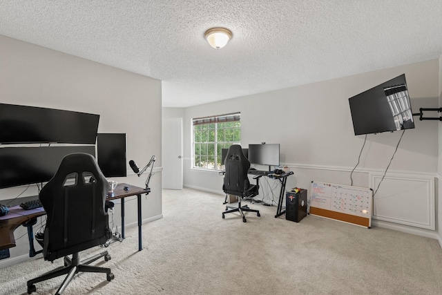 carpeted office space featuring a textured ceiling