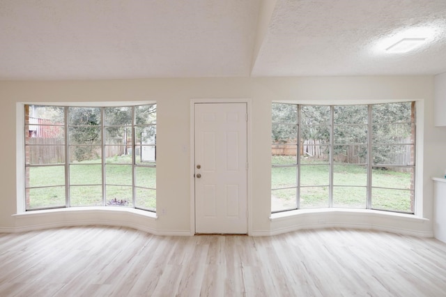 interior space featuring light hardwood / wood-style flooring and a textured ceiling