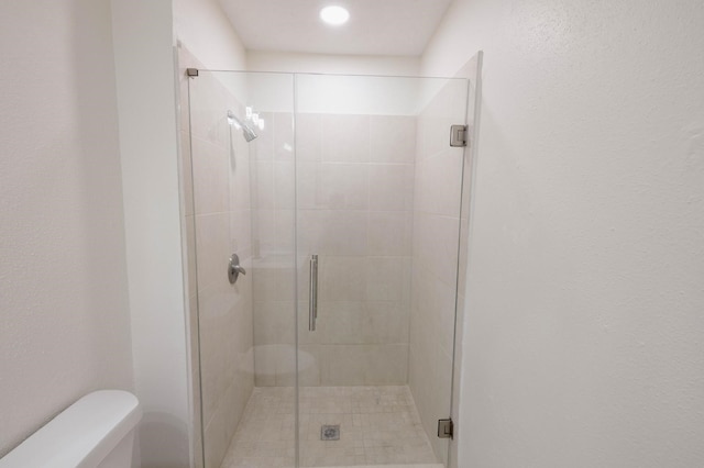 bathroom with toilet and walk in shower