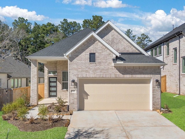 view of front of house featuring brick siding, roof with shingles, an attached garage, fence, and driveway