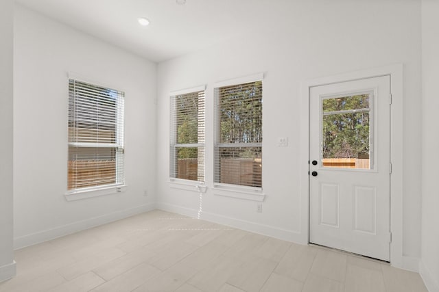 doorway to outside featuring recessed lighting and baseboards