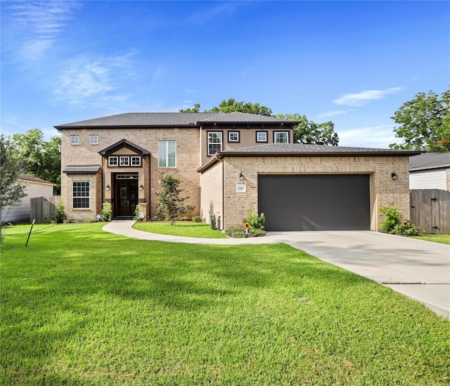 prairie-style home with a garage and a front lawn