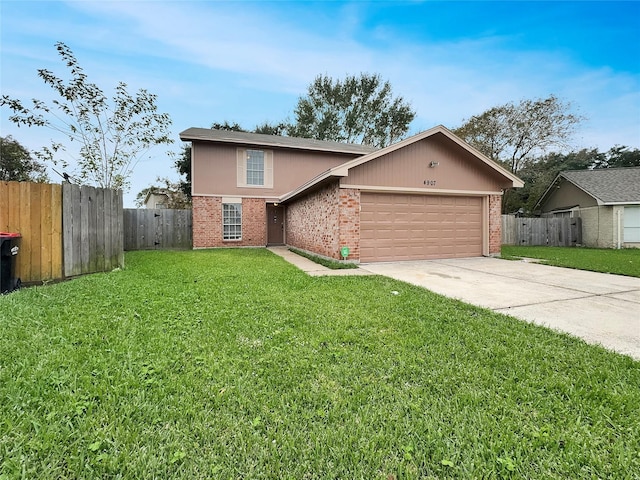 view of front of home with a front yard and a garage