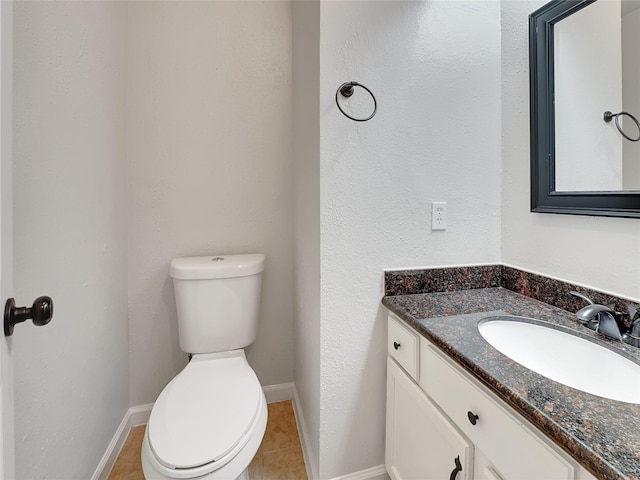 bathroom featuring tile patterned floors, vanity, and toilet