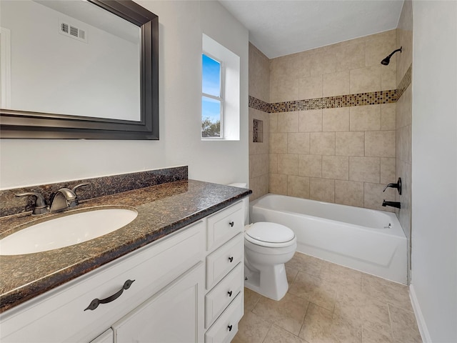 full bathroom featuring vanity, toilet, and tiled shower / bath