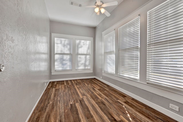 spare room featuring dark hardwood / wood-style flooring and ceiling fan