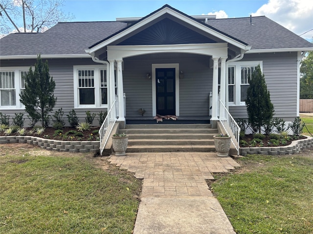 view of front of property with a porch and a front yard