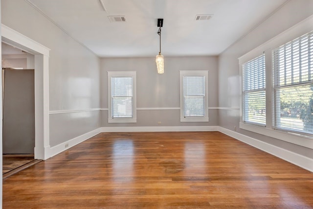 unfurnished dining area featuring wood-type flooring and ornamental molding