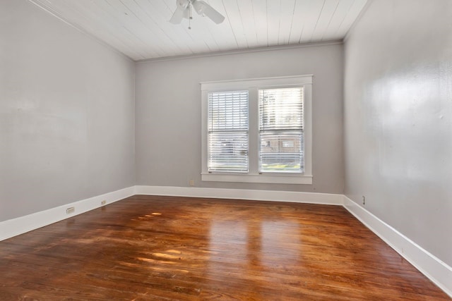 spare room with ceiling fan, crown molding, wood ceiling, and dark wood-type flooring